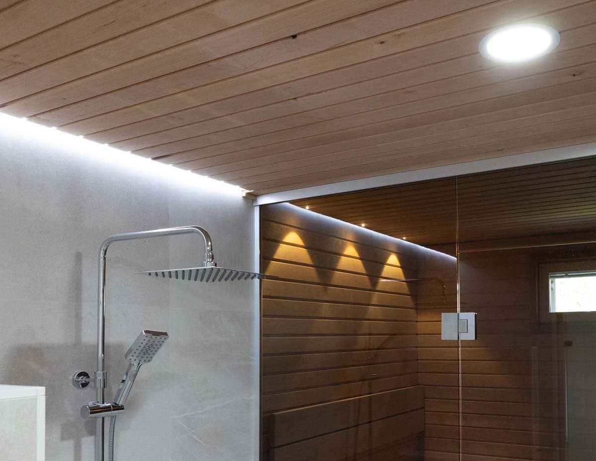 Warm light in the steam room, neutral in the washrooms. LedStore.fi
